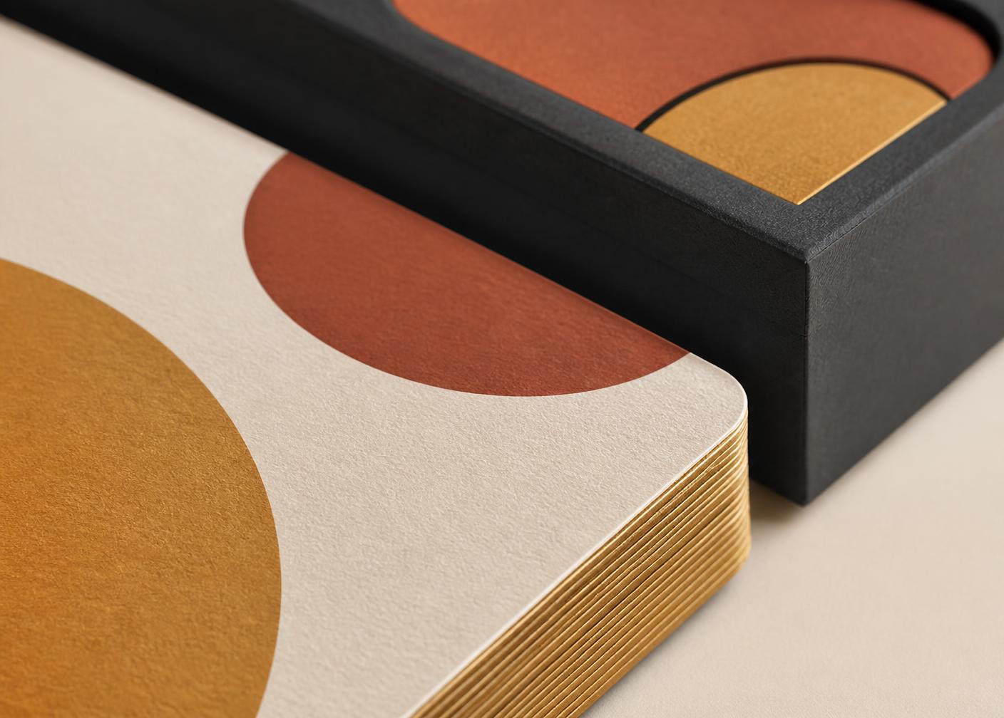 Detail of premium finishes: gilded edge, textured paper and soft-touch box